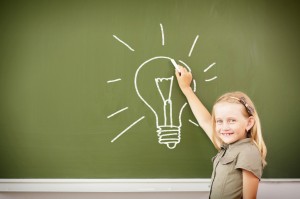 scoolgirl standing near blackboard